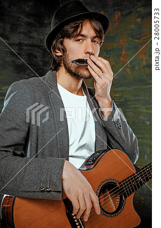 Cool guy with hat playing guitar on gray Cool guy with hat playing guitar on gray 28005733