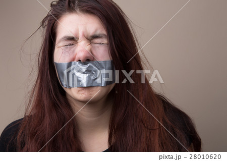 Girl with tape on face 28010620