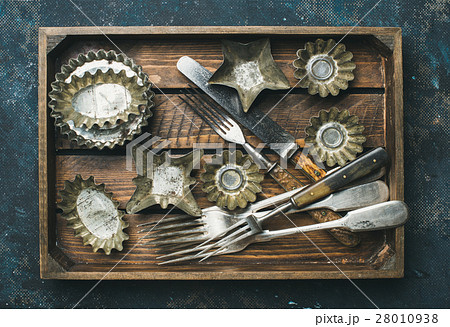 Old vintage tin baking molds and cutlery in wooden 28010938