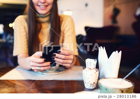 Close up of women's hands holding cell telephone Close up of women's hands holding cell telephone 28013186