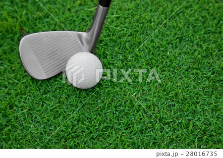 iron golf club and ball on a green grass iron golf club and ball on a green grass 28016735