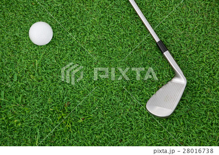 iron golf club and ball on a green grass 28016738