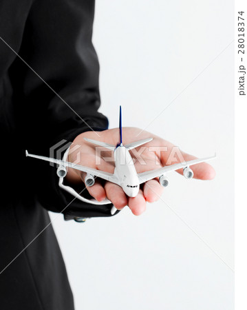 Airplane model on a business woman's hand. 28018374