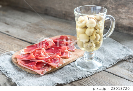 Slices of jamon on the wooden board Slices of jamon on the wooden board 28018720