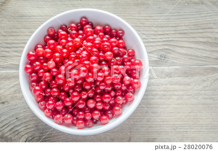 Bowl with fresh redcurrant on the wooden table 28020076