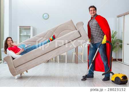 Superhero husband helping his wife at home Superhero husband helping his wife at home 28023152
