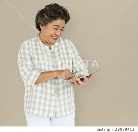 Mature Woman Holding Tablet Concept Mature Woman Holding Tablet Concept 28029413
