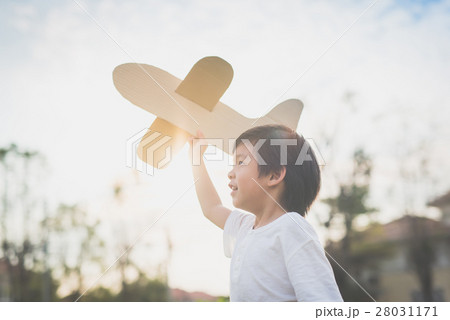Cute Asian child playing cardboard airplane Cute Asian child playing cardboard airplane 28031171