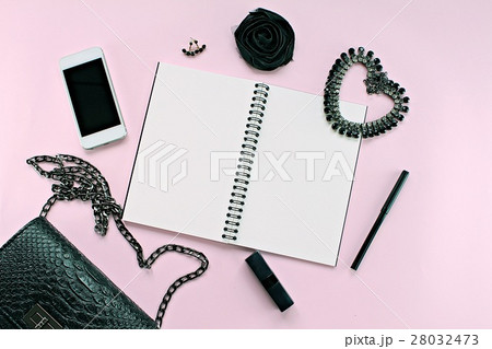 Woman bag with accessories on pink background 28032473