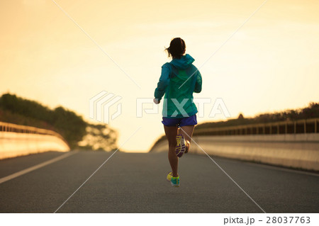 young fitness  woman runner running on city road 28037763