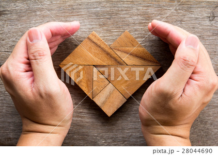 Hand cover tangram puzzle in heart shape 28044690