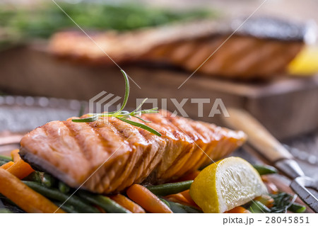 Grilled salmon, sesame seeds and herb decoration.  28045851
