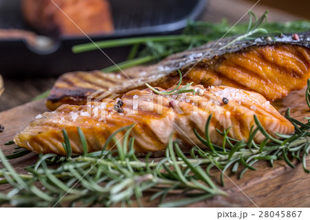 Grilled salmon, sesame seeds and herb decoration. Grilled salmon, sesame seeds and herb decoration. 28045867
