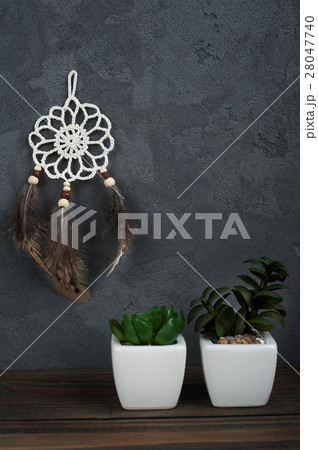 Small dream catcher on concrete background 28047740