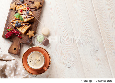 Coffee, sweets and waffles with berries 28048300
