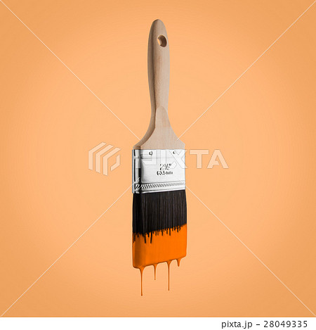 Paintbrush loaded with orange color dripping. 28049335