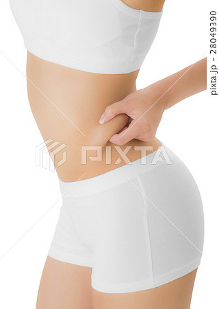 Woman checks and pinching Excess fat on her hip. 28049390