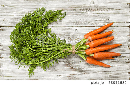 Carrots bunch on bright rustic wooden background Carrots bunch on bright rustic wooden background 28051682
