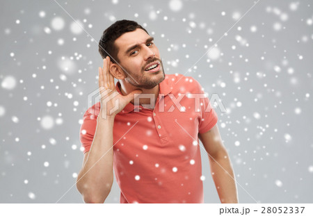 man having hearing problem listening to something 28052337