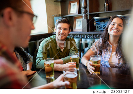 happy friends drinking beer at bar or pub 28052427