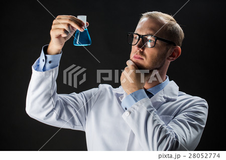 young scientist holding test flask with chemical young scientist holding test flask with chemical 28052774