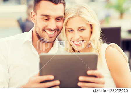 happy couple with tablet pc at restaurant lounge happy couple with tablet pc at restaurant lounge 28052970