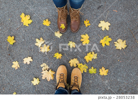 couple of feet in boots and autumn leaves 28053238