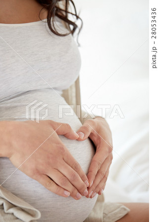 close up of pregnant woman making heart gesture close up of pregnant woman making heart gesture 28053436