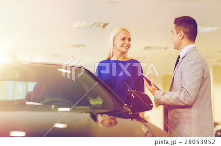 happy woman with car dealer in auto show or salon 28053952