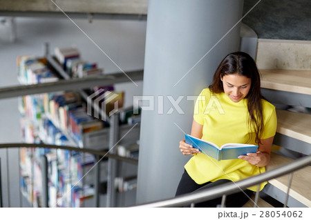 high school student girl reading book at library high school student girl reading book at library 28054062