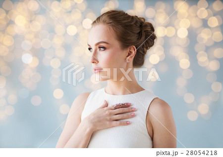 smiling woman in white dress with diamond jewelry smiling woman in white dress with diamond jewelry 28054218