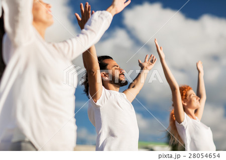 group of people making yoga exercises outdoors 28054654