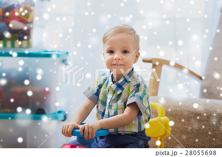 happy little baby boy driving ride-on car at home happy little baby boy driving ride-on car at home 28055698