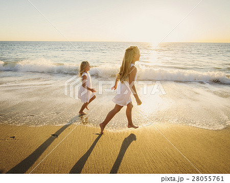 Girls (6-7, 8-9) running on beach Girls (6-7, 8-9) running on beach 28055761