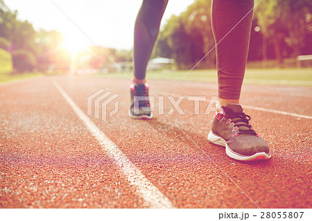 close up of woman feet running on track from back close up of woman feet running on track from back 28055807