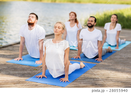 group of people making yoga exercises outdoors 28055940