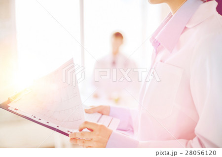 female holding clipboard with cardiogram 28056120