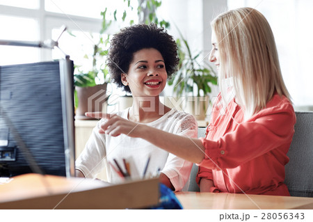 happy women or students with computer in office 28056343