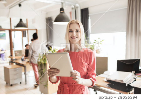 happy creative female office worker with tablet pc 28056594