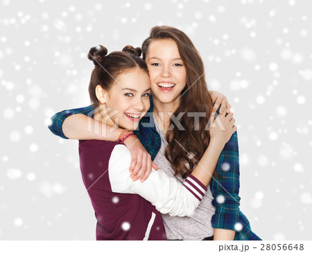 happy pretty teenage girls hugging over snow happy pretty teenage girls hugging over snow 28056648