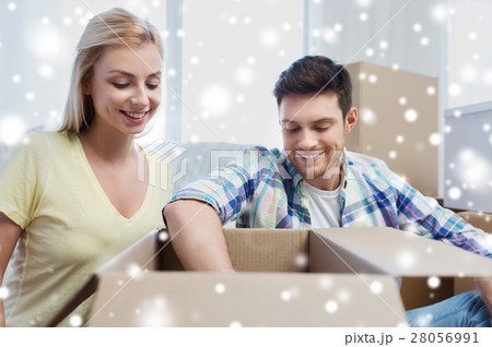 smiling couple with big boxes moving to new home smiling couple with big boxes moving to new home 28056991