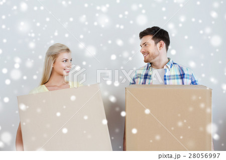 smiling couple with big boxes moving to new home smiling couple with big boxes moving to new home 28056997