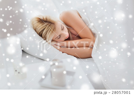 young woman sleeping in bed at home bedroom 28057001