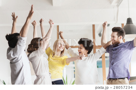 happy creative team celebrating victory in office 28057234