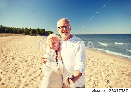 seniors taking picture with selfie stick on beach seniors taking picture with selfie stick on beach 28057587