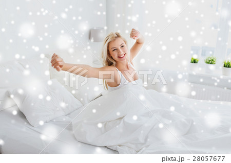young woman stretching in bed at home bedroom young woman stretching in bed at home bedroom 28057677