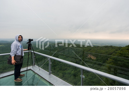 Young man with taking a photo on the top of 28057898