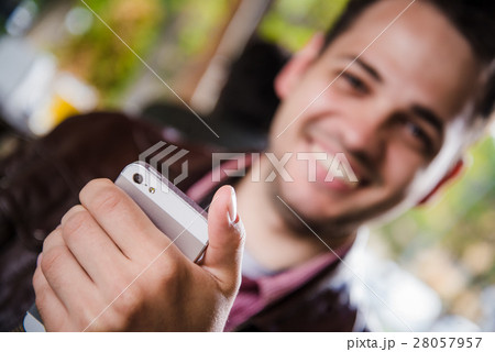 Happy young man browsing internet on smartphone 28057957