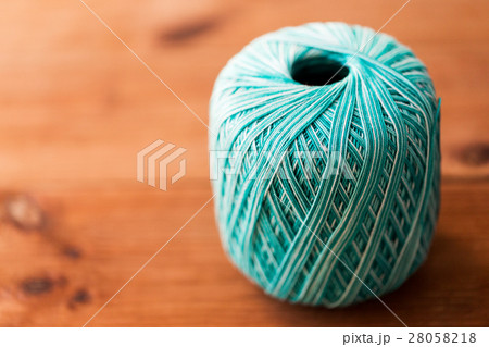 ball of turquoise cotton yarn on wood ball of turquoise cotton yarn on wood 28058218