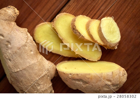 close up of ginger root on wooden table 28058302